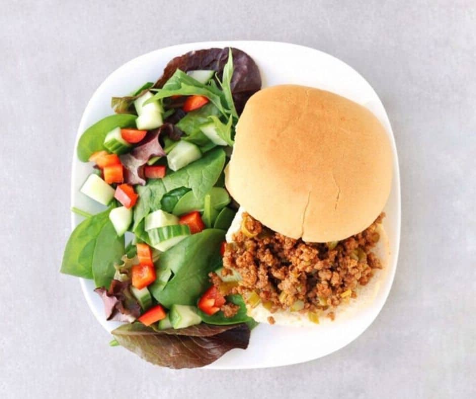 a plate of Low FODMAP sloppy Joe sandwich with a salad