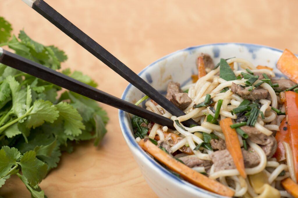 a bowl of Low FODMAP stir fried beef with oyster sauce and rice noodles