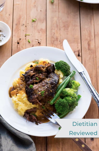 a bowl of Low FODMAP tender beef cheeks with broccoli and mashed potatoes