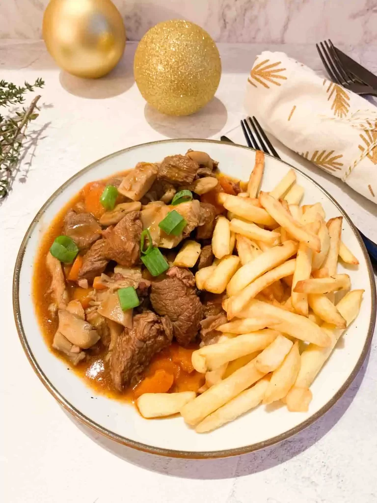 a plate of low fodmap boeuf bourguignon with frites