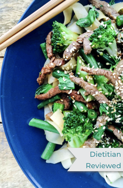 a plate of lime and sesame beef stir fry with chopsticks